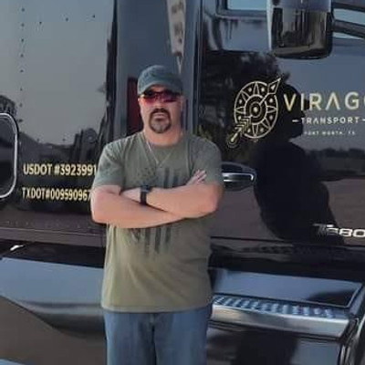 Daryl standing beside a Virago Transport truck